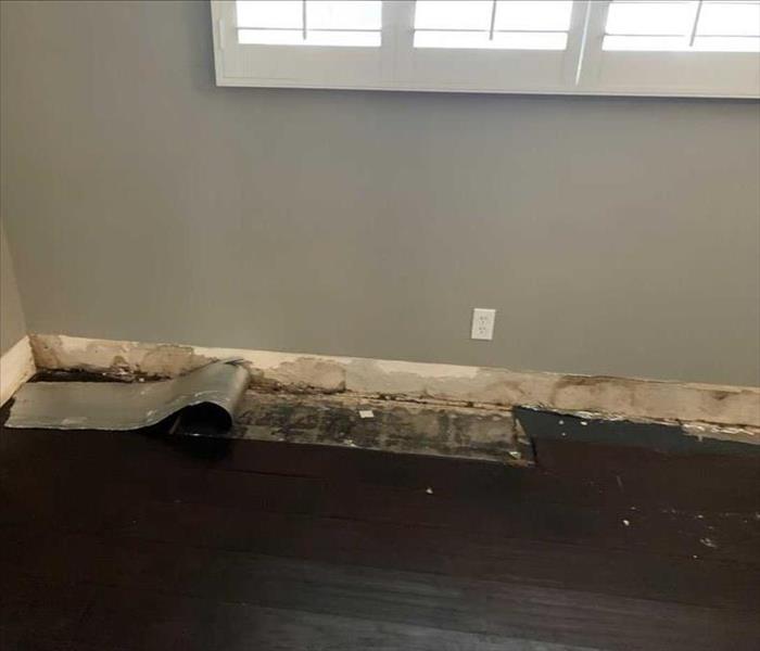 Baseboard and Flooring Damaged by Contaminated Water